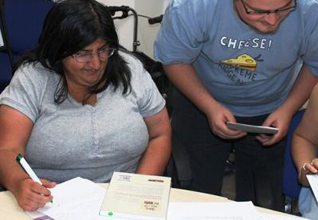 Advisor assisting a client with paperwork for housing support.