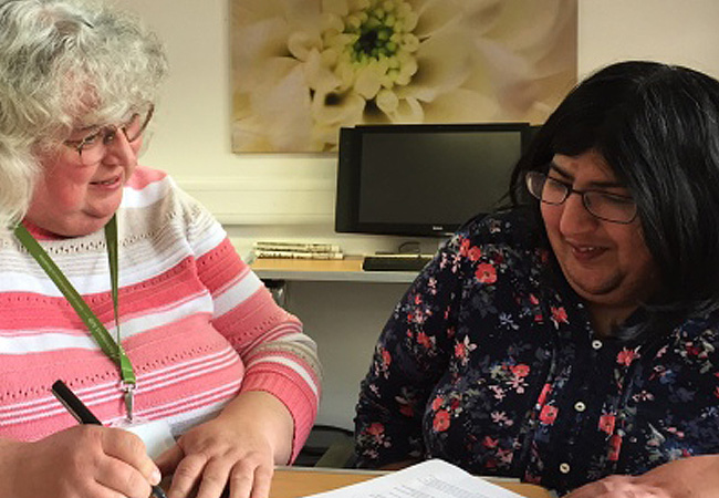 Advisor and client reviewing documents together during a money advice session.