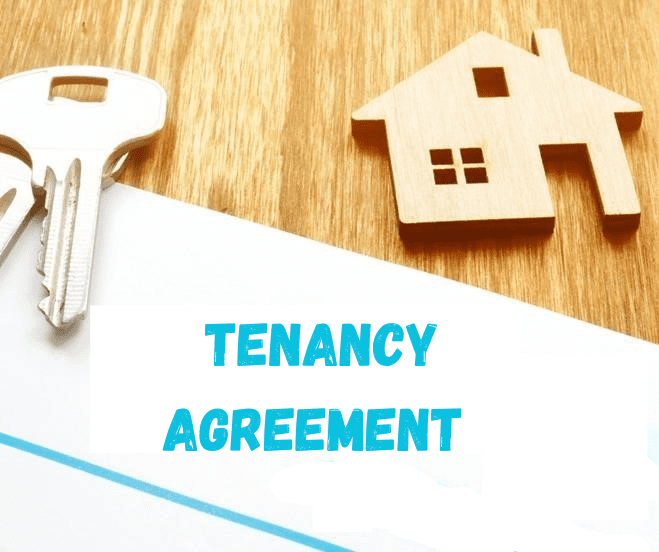 A set of keys and a small wooden house rest on a wooden surface next to a document labelled Tenancy Agreement in bold blue letters, highlighting the importance of the Renters’ Rights Act.