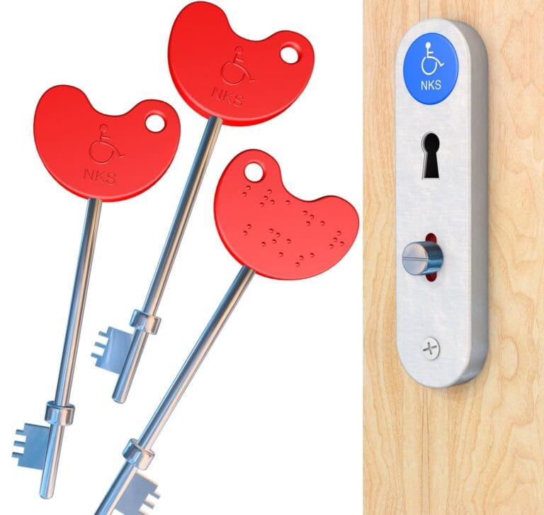 Three red keys labelled NKS, one with braille, next to a metal door lock with a blue wheelchair symbol indicating Accessible Toilets, commonly known as RADAR Keys, on a wooden surface.